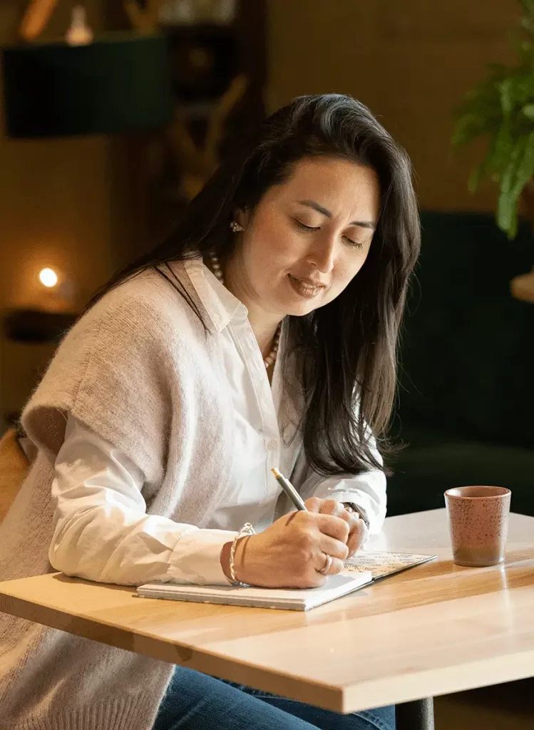 Coach Bruna Mathys in a moment of thoughtful reflection, representing the deep work she facilitates with her clients.